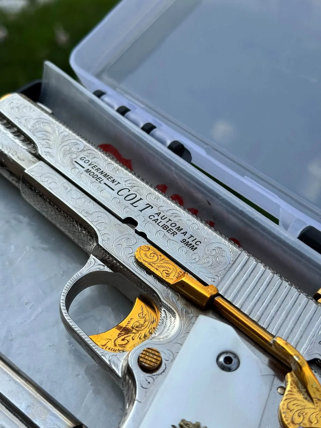 Close-up of an engraved Colt 1911 with gold detailing