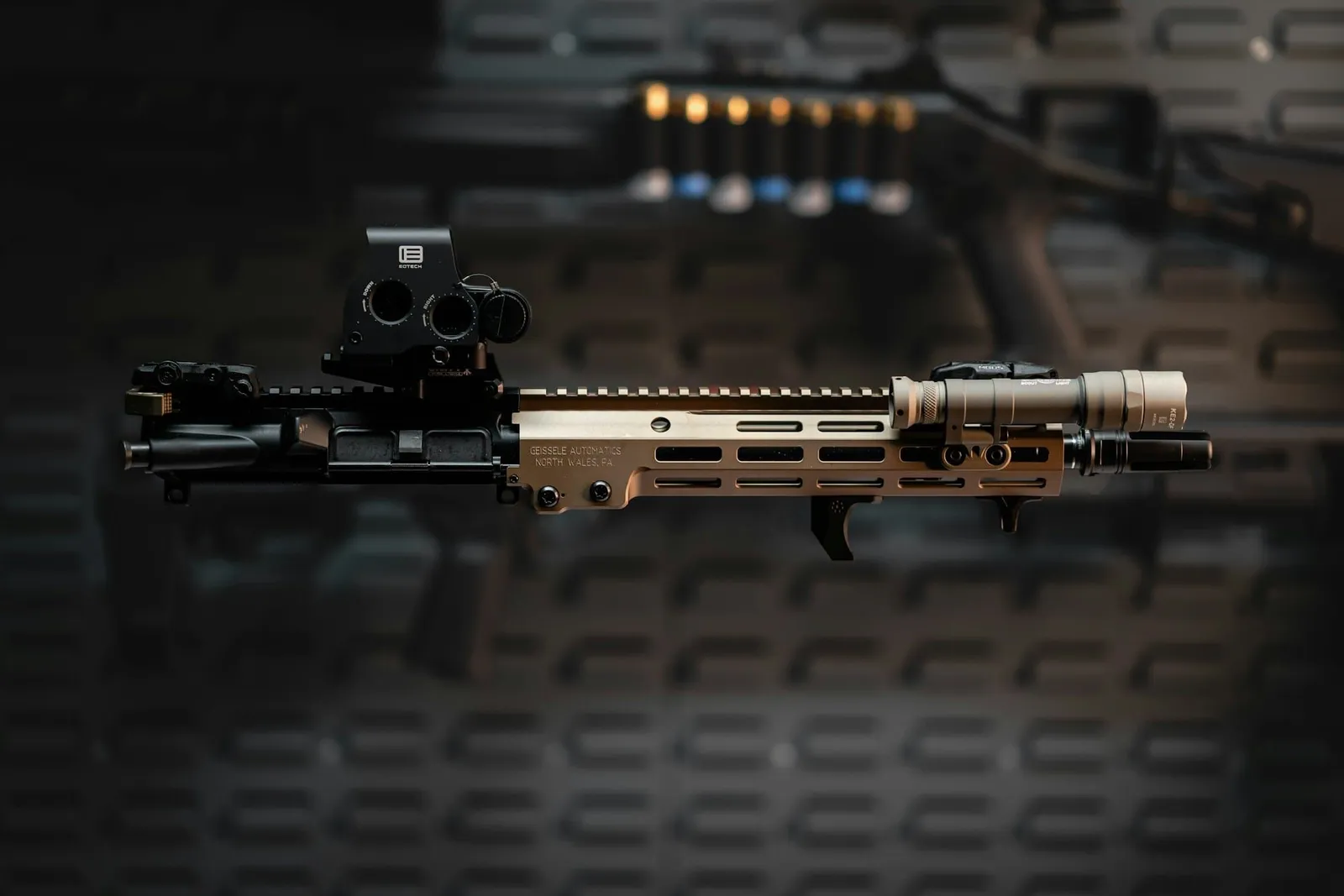 A rifle photographed against a black background